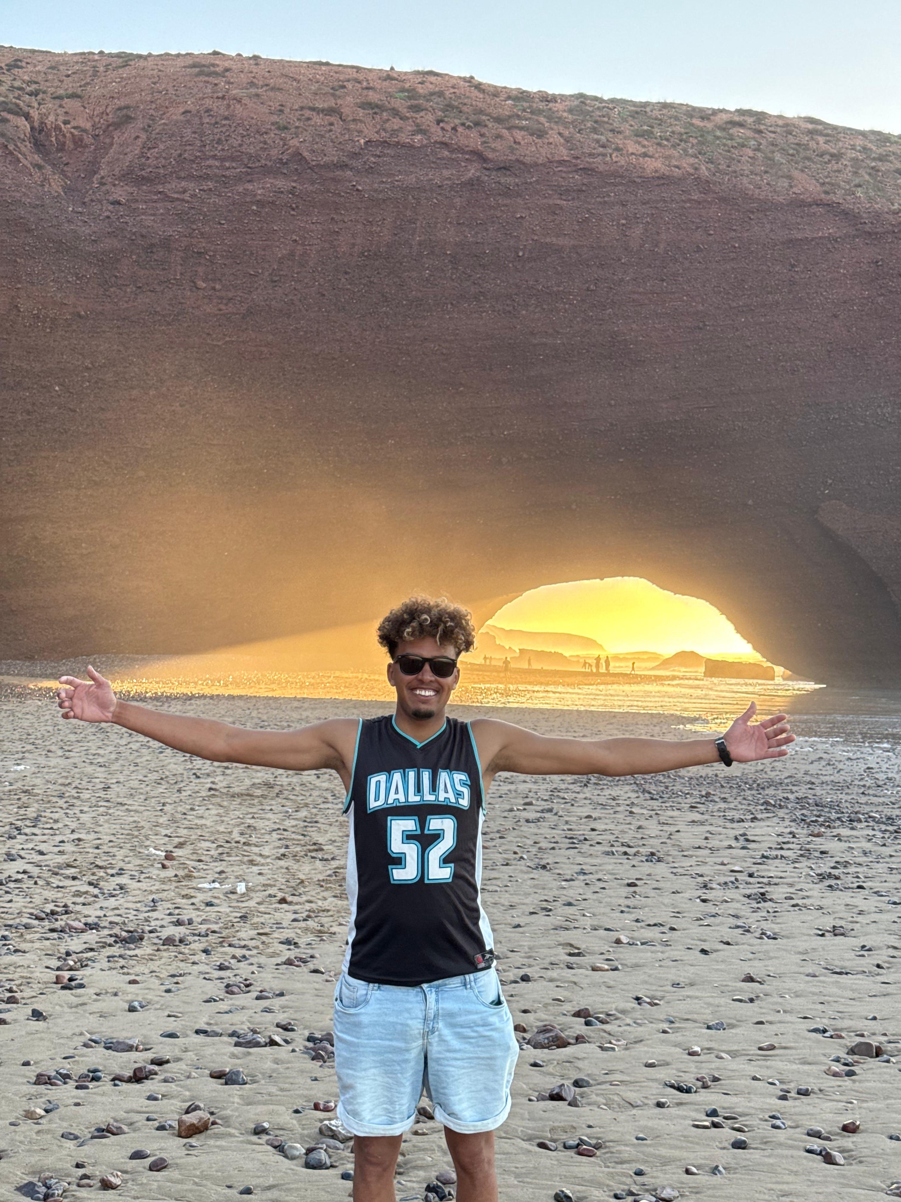The red rock arch of Legzira beach glowing at sunset