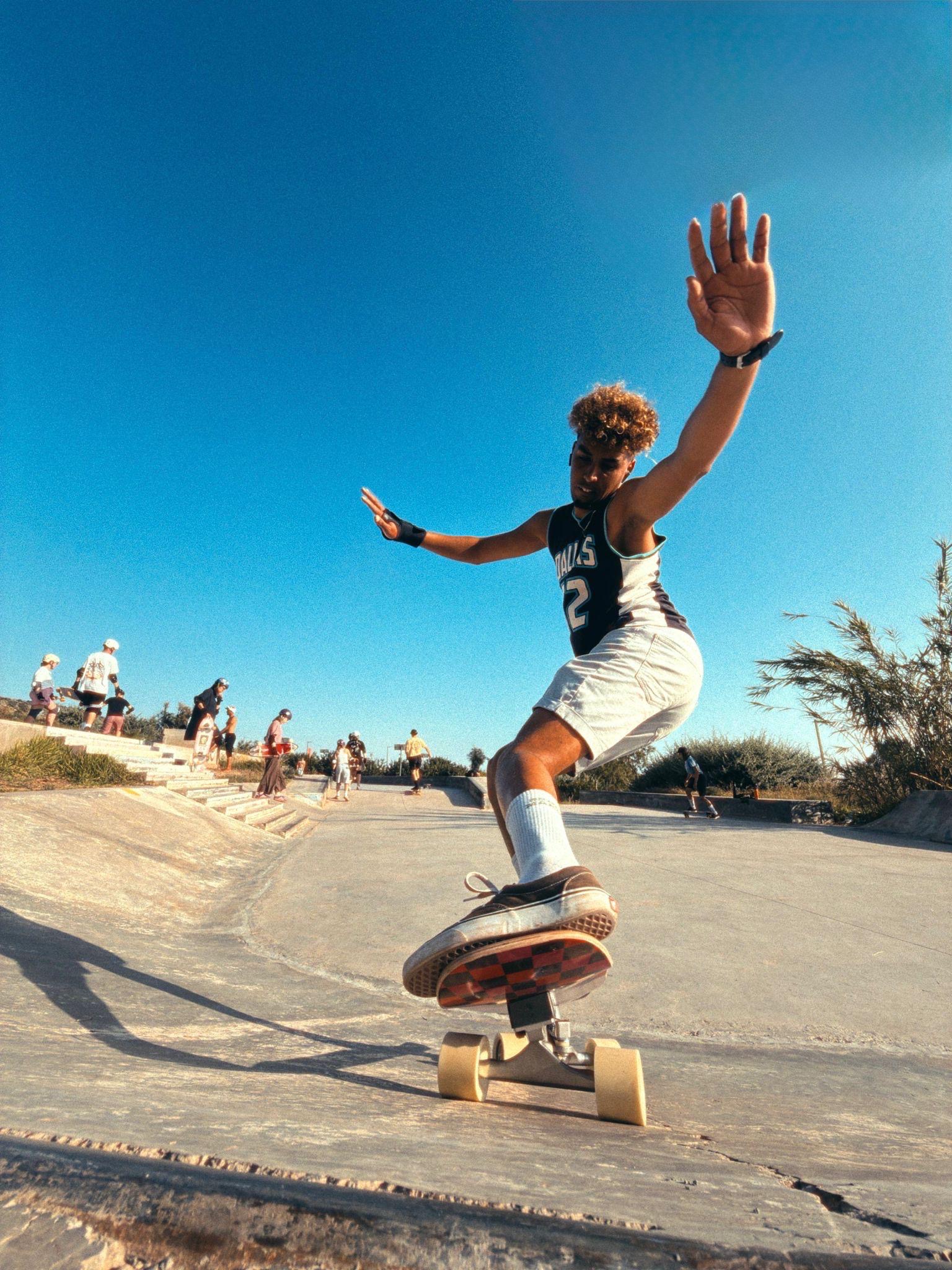 Coach carving a surfskate through the bowl at the skate park
