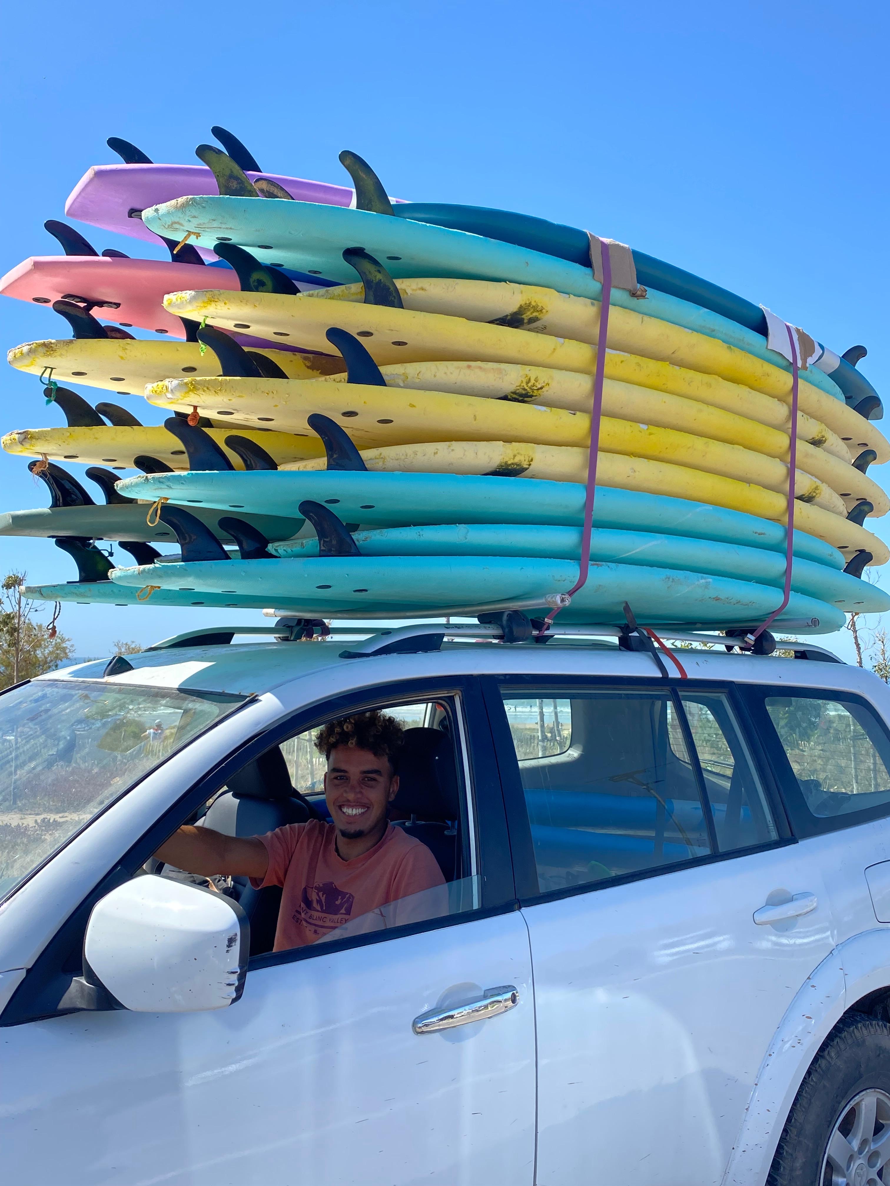 Faysal behind the wheel, gear packed for the next surf spot